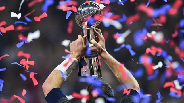 New England Patriots quarterback Tom Brady holding Lombardi Trophy