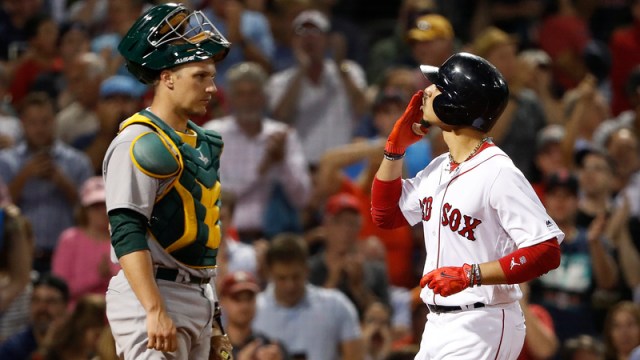Atletics Catcher Dustin Garneau and Red Sox outfielder Mookie Betts