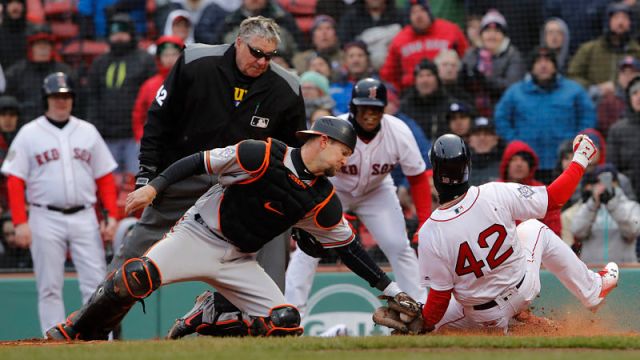 Boston Red Sox outfielder Andrew Benintendi and Baltimore Orioles catcher Caleb Joseph