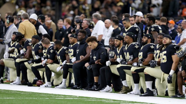 Saints players kneel during the National Anthem