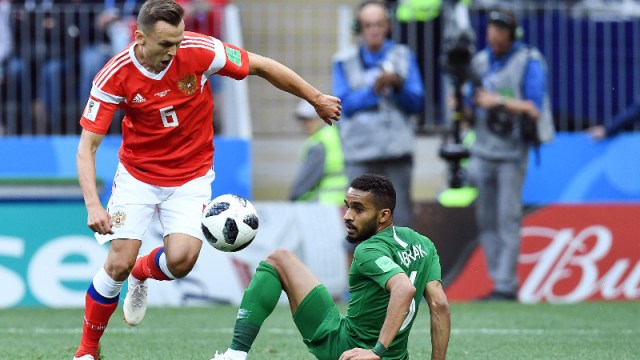 Russia midfielder Denis Cheryshev (6) and Saudi Arabia player Mohammed Alburayk