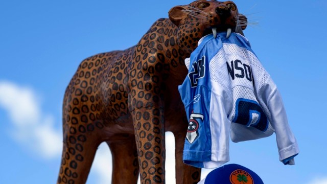 Jaguars mascot holds a Titans jersey