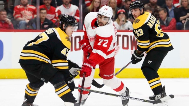 Detroit Red Wings Center Andreas Athanasiou And Boston Bruins' Torey Krug And Brad Marchand