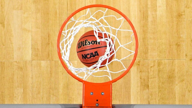 A view of a basketball going through the net