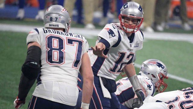 New England Patriots quarterback Tom Brady (12) gestures toward tight end Rob Gronkowski (87)