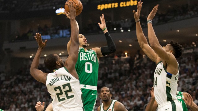 Boston Celtics forward Jayson Tatum (0) and Milwaukee Bucks forward Khris Middleton (22) and forward Giannis Antetokounmpo (34)