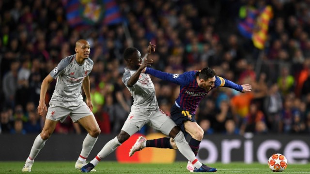 Barcelona's Lionel Messi (right) and Liverpool's Fabinho (left) and Naby Keita (center)