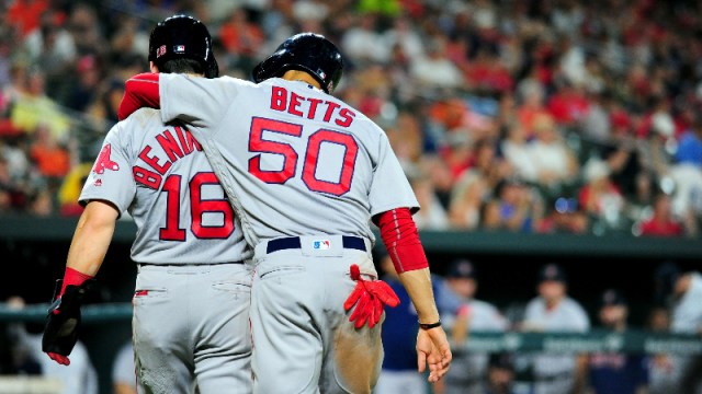 Boston Red Sox outfielders Mookie Betts (50) and Andrew Benintendi (16)