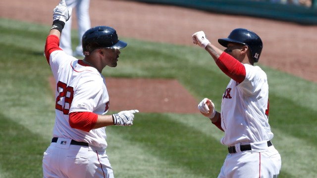 Boston Red Sox left fielder J.D. Martinez (28) and third baseman Rafael Devers (11)