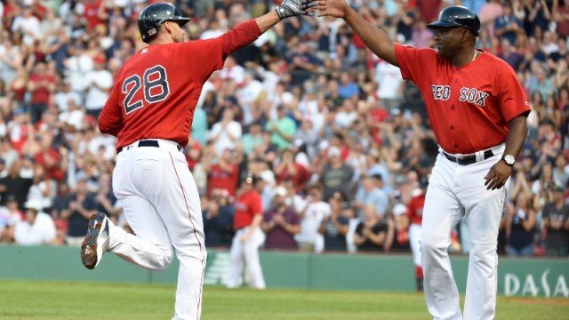 Boston Red Sox designated hitter J.D. Martinez (28) and third base coach Carlos Febles (52)