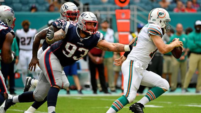 New England Patriots defensive tackle Lawrence Guy and Miami Dolphins quarterback Ryan Fitzpatrick