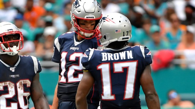 New England Patriots quarterback Tom Brady (center), former wide receiver Antonio Brown (right) and running back Sony Michel (left)