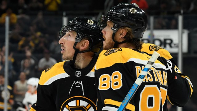 Boston Bruins left wing Brad Marchand (63) and right wing David Pastrnak (88)