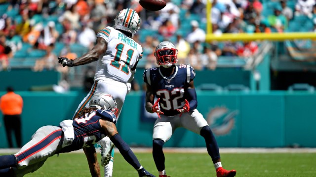 New England Patriots free safety Devin McCourty (32) and Miami Dolphins wide receiver DeVante Parker (11)