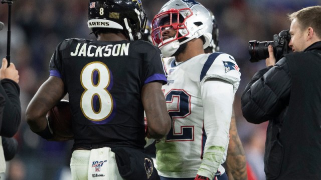 Baltimore Ravens quarterback Lamar Jackson (8) and New England Patriots linebacker Elandon Roberts (52)