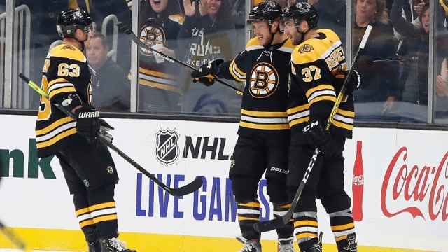 Boston Bruins right wing David Pastrnak (88), left wing Brad Marchand (63) and center Patrice Bergeron (37)