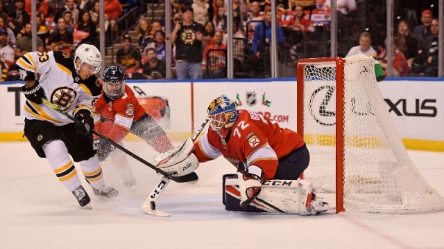 Boston Bruins left wing Brad Marchand (63) and Florida Panthers goaltender Sergei Bobrovsky (72)