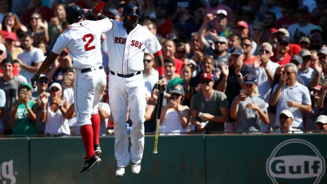 Boston Red Sox shortstop Xander Bogaerts (2) and former designated hitter David Ortiz (34)