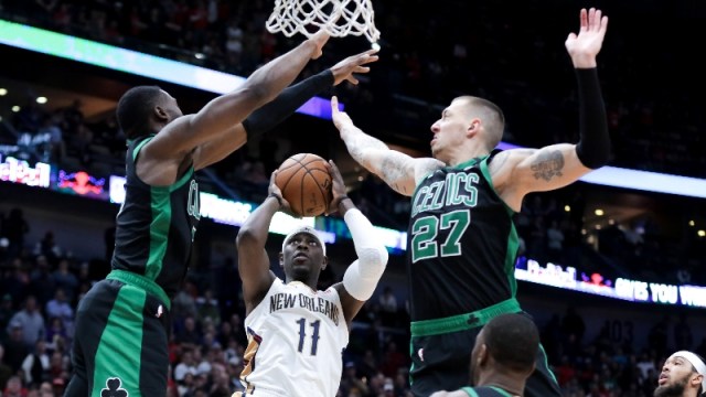 Boston Celtics guard Jaylen Brown (7) and center Daniel Theis (27) and New Orleans Pelicans guard Jrue Holiday (11)