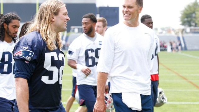 New England Patriots defensive end Chase Winovich (52) and quarterback Tom Brady (right)
