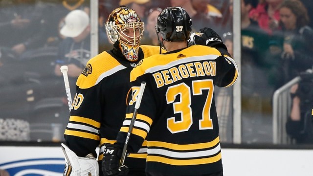 Boston Bruins goaltender Tuukka Rask (40) and center Patrice Bergeron (37)