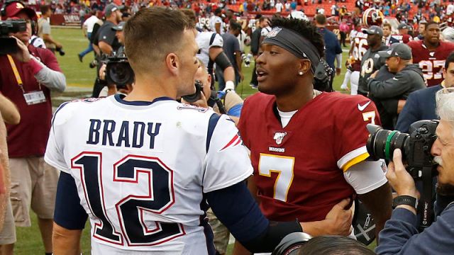 Former New England Patriots quarterback Tom Brady greets Washington Redskins quarterback Dwayne Haskins