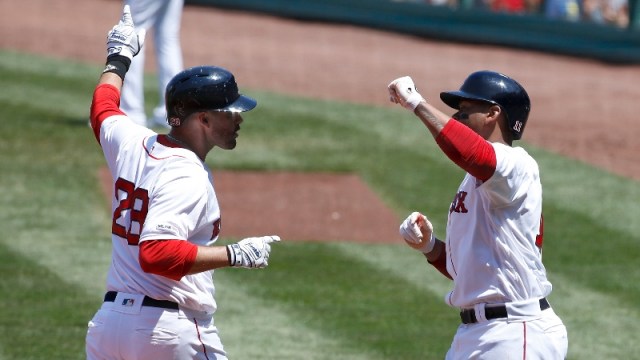 Boston Red Sox designated hitter J.D. Martinez (28) and third baseman Rafael Devers (11)