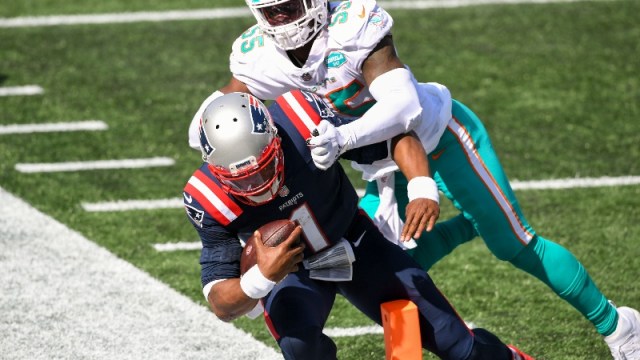 New England Patriots quarterback Cam Newton (1) and Miami Dolphins outside linebacker Jerome Baker (55)