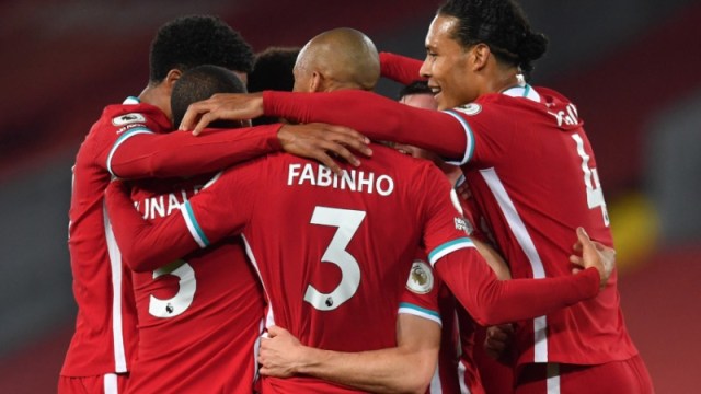 Liverpool midfielder Fabinho (center), defender Virgil van Dijk (right) and teammates