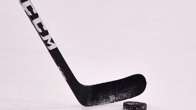 A view of a St. Louis Blues players hockey stick and puck