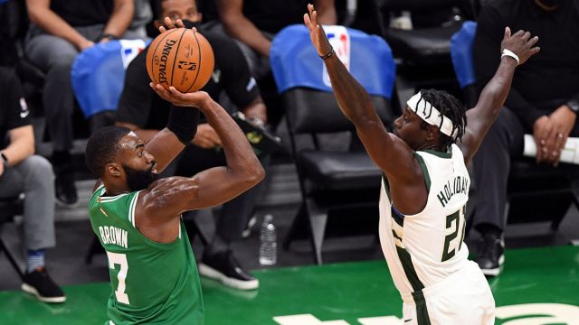 Boston Celtics guard Jaylen Brown and Milwaukee Bucks guard Jrue Holiday