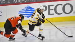 Boston Bruins right wing David Pastrnak (88) and Philadelphia Flyers defenseman Shayne Gostisbehere (53)