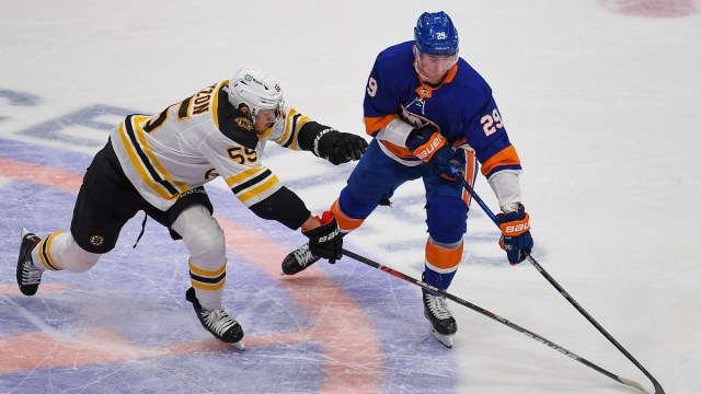 Boston Bruins defenseman Jeremy Lauzon (55) and New York Islanders center Brock Nelson (29)