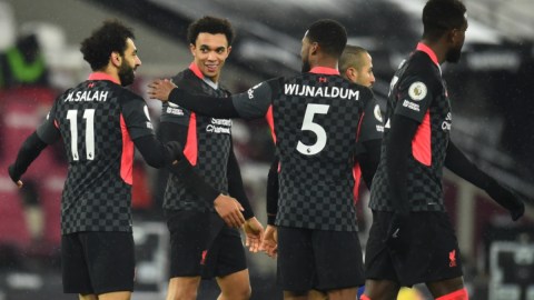 Liverpool forward Mohamed Salah (11), defender Trent Alexander-Arnold (66) and midfielder Georginio Wijnaldum