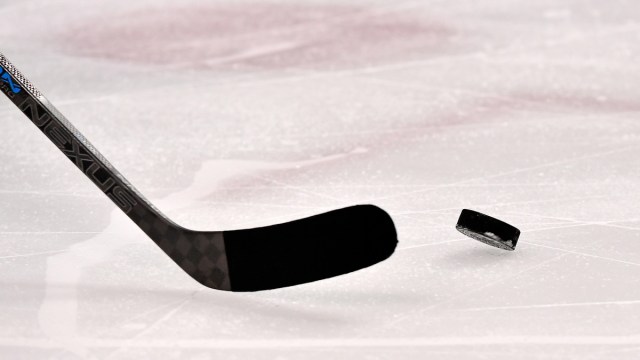 General view of hockey puck and stick