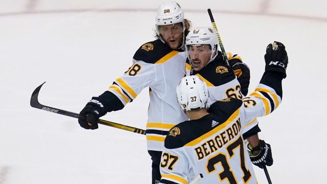 Boston Bruins wingers David Pastrnak and Brad Marchand and center Patrice Bergeron