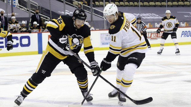 Boston Bruins forward Trent Frederic, Pittsburgh Penguins defenseman Brian Dumoulin
