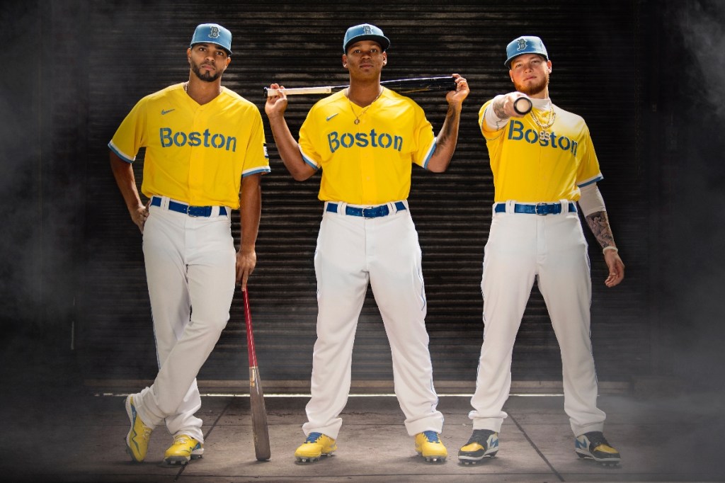 Boston Red Sox shortstop Xander Bogaerts (left), third baseman Rafael Devers (center) and outfielder Alex Verdugo
