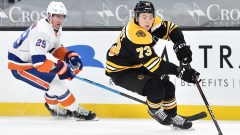 Boston Bruins defenseman Charlie McAvoy (73) and New York Islanders center Brock Nelson (29)