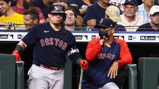 Boston Red Sox manager Alex Cora (13) and catcher Christian Vazquez (7)