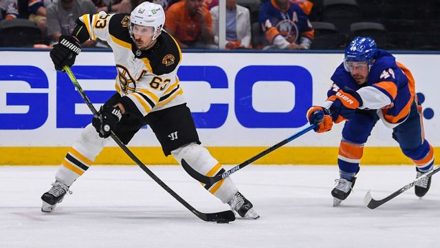 Boston Bruins left wing Brad Marchand and New York Islanders center Jean-Gabriel Pageau