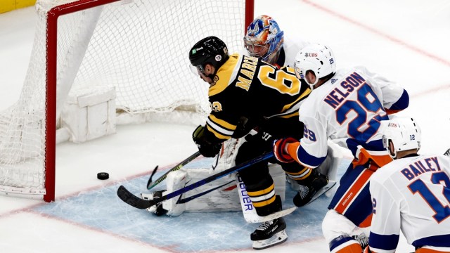 Boston Bruins left wing Brad Marchand (63), and New York Islanders goaltender Semyon Varlamov (40)