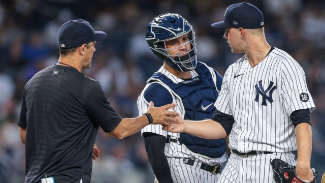 New York Yankees pitcher Michael King, catcher Gary Sanchez, manager Aaron Boone