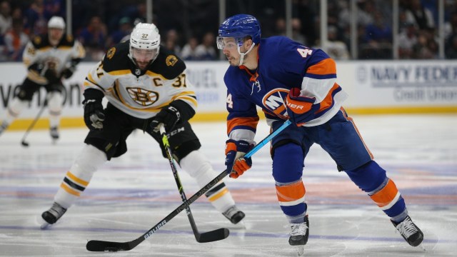 New York Islanders center Jean-Gabriel Pageau (44) plays the puck against Boston Bruins center Patrice Bergeron (37)