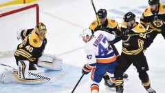 Boston Bruins goalie Tuukka Rask, New York Islanders forward Leo Komarov