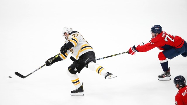 Boston Bruins center Patrice Bergeron (37) and Washington Capitals left wing Conor Sheary (73)