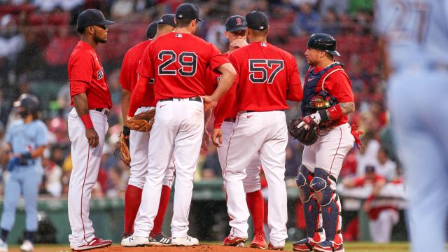 Boston Red Sox players huddle at the mound
