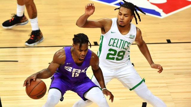 Sacramento Kings guard Davion Mitchell (15) and Boston Celtics guard Juhann Begarin (29)