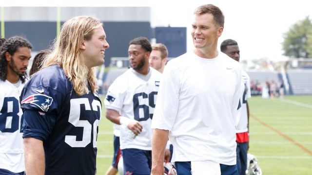 New England Patriots outside linebacker Chase Winovich (52) and quarterback Tom Brady (right)