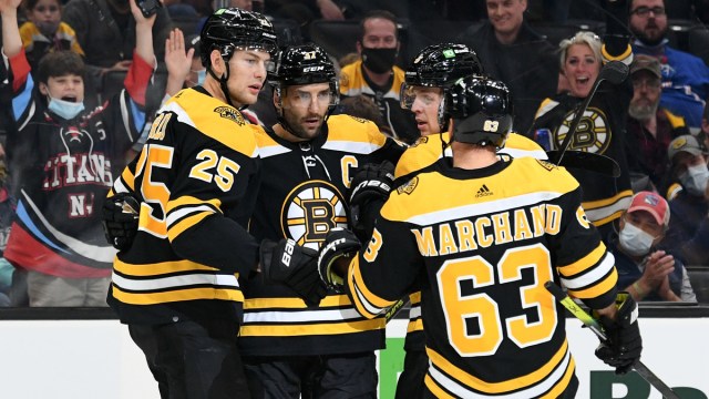 Boston Bruins forwards Patrice Bergeron and Brad Marchand, defensemen Brandon Carlo and Mike Reilly